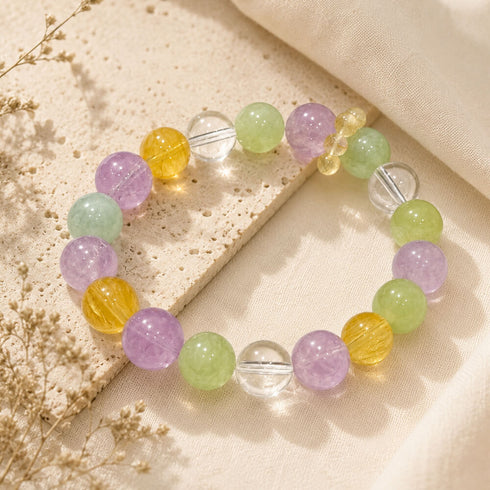 Crystal beaded bracelet with purple, mint green, and golden yellow beads and clear dividers