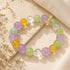 Crystal beaded bracelet with purple, mint green, and golden yellow beads and clear dividers