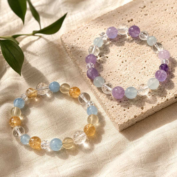 Pair of crystal bracelets with purple, light blue, clear, and amber round beads
