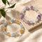 Pair of crystal bracelets with purple, light blue, clear, and amber round beads
