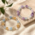 Pair of crystal bracelets with purple, light blue, clear, and amber round beads