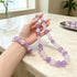Lilac amethyst-and-quartz beaded necklace and bracelet set on tabletop