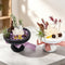 Crystal garden kit with two stone planters: dark bowl with purple crystals, white bowl with clear crystals