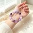 Amethyst and rose quartz beaded bracelet on open hand, mixed purple and pink stones