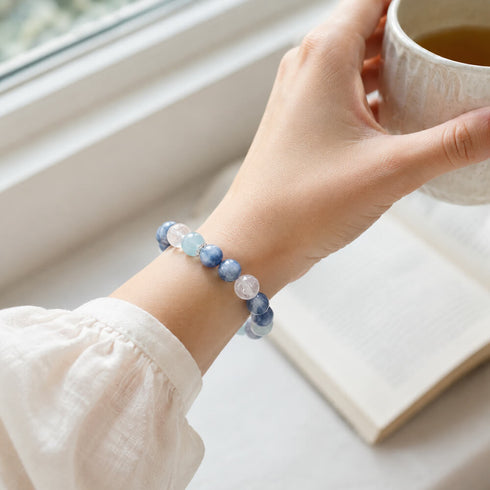 Blue and aqua beaded crystal bracelet on wrist, round stones with clear crystal beads
