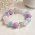 Gemstone bead bracelet with pastel round beads in lilac, aqua, and pale green tones