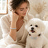 Woman and white dog wearing aquamarine and rose quartz beaded pet collar and bracelet