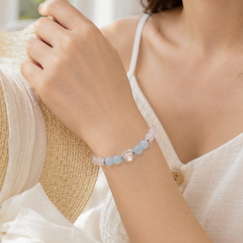 Rose quartz and aquamarine beaded bracelet on wrist with clear center bead