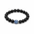 Black round bead bracelet with blue round center crystal stone, studio view