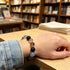 Crystal bead bracelet on wrist: black and blue stones with clear accents