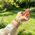 Citrine crystal bracelet worn on wrist, oval faceted yellow stone beads