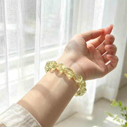 Citrine crystal bracelet on hand, oval faceted yellow stone beads on elastic