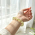 Citrine crystal bracelet on hand, oval faceted yellow stone beads on elastic