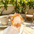 Citrine crystal bracelet held in hand, round orange, yellow, and clear beads