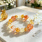 Citrine crystal beaded bracelet with orange, yellow, and clear stones in a circle