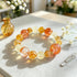Citrine crystal beaded bracelet with orange, yellow, and clear stones in a circle