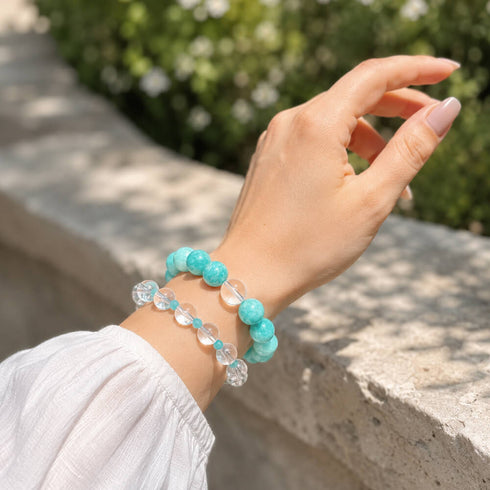 Turquoise and clear crystal bead bracelet on wrist, elastic stretch design