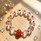 Clear quartz crystal bead bracelet with red round center stone and red accents