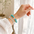 Turquoise and clear crystal bead bracelet on hand, elastic stretch bracelet