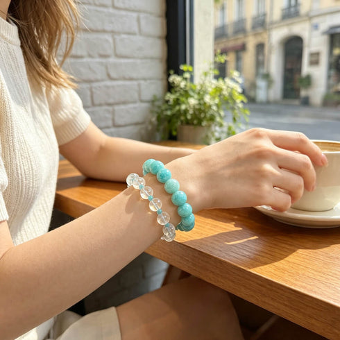 Turquoise and clear crystal bead bracelets on arm, elastic stretch fit