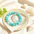 Turquoise and clear crystal bead bracelets arranged on fabric, elastic stretch