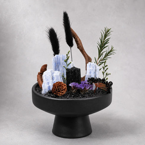 Crystal money tree ornament on black pedestal with blue crystal slabs and black stone accents