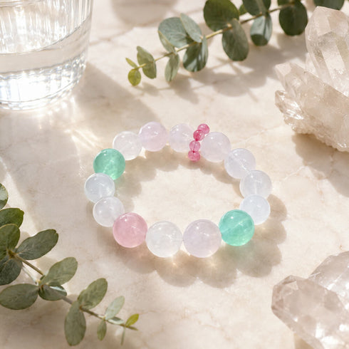 Crystal beaded bracelet with clear round stones, pink center beads, and mint beads
