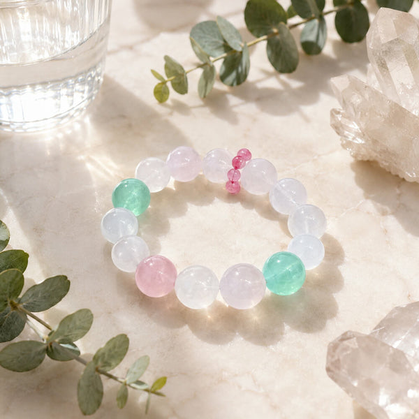Crystal beaded bracelet with clear round stones, pink center beads, and mint beads