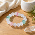 Crystal beaded bracelet with clear, pale pink, and mint green beads on wood
