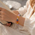 Multi-crystal gemstone bracelet with round pastel beads on a wrist