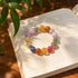 Multi-crystal gemstone bracelet with multicolor round beads on an open book