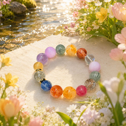 Multi-crystal gemstone bracelet with multicolor round beads on a stone by flowers