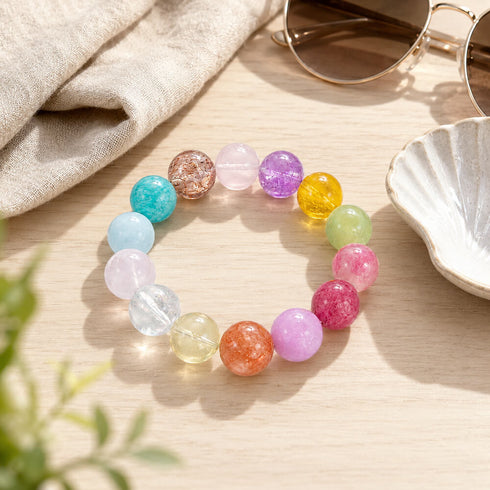 Beaded crystal bracelet with assorted pastel and bright round beads on tabletop