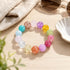Beaded crystal bracelet with assorted pastel and bright round beads on tabletop