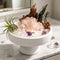 White bowl crystal garden centerpiece with pink rose quartz cluster, clear crystals, purple accents