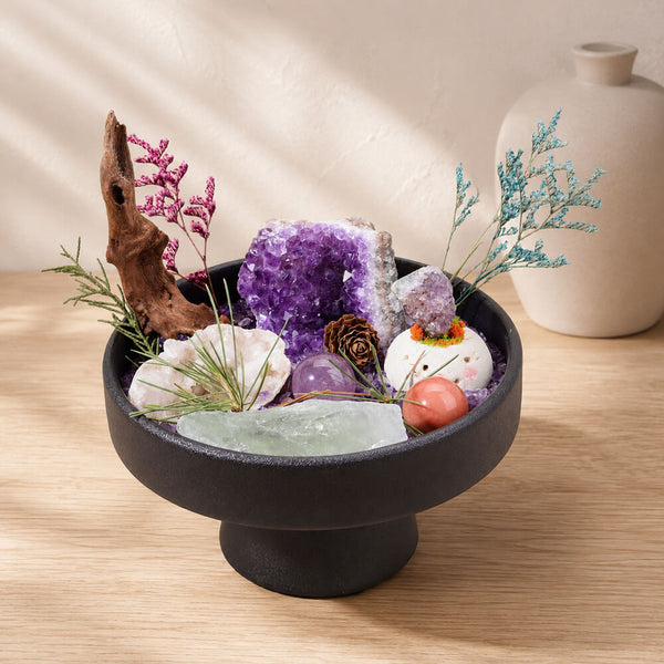 Black pedestal bowl with purple amethyst and clear quartz crystals and decorative stems