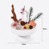 White pedestal bowl filled with clear quartz, citrine, and pink crystal pieces