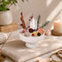 White pedestal bowl centerpiece with clear quartz and citrine crystals