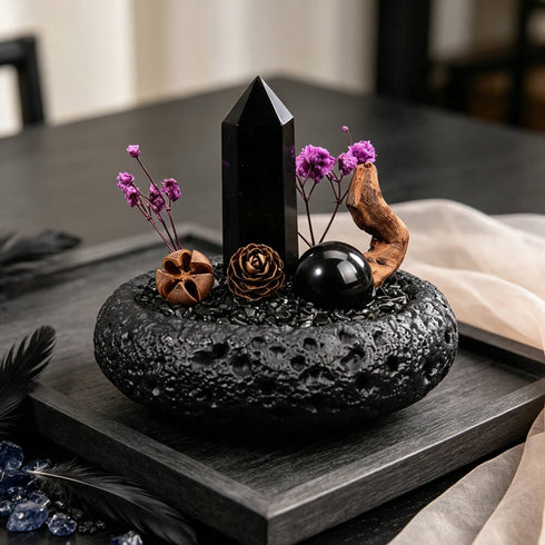 Water intention crystal garden set with black crystal point and purple flowers in dark stone bowl