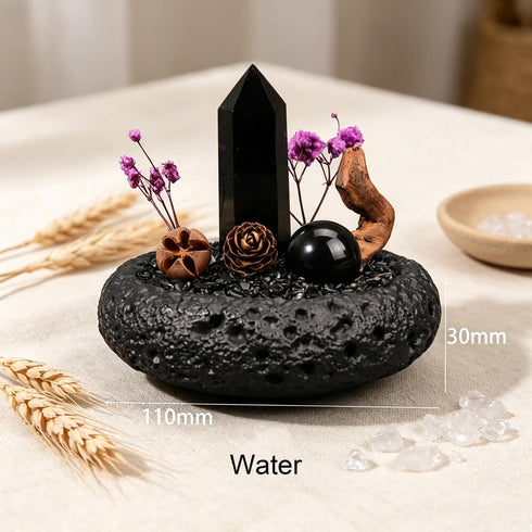 Water intention crystal garden set with black crystal point and purple flowers in dark stone bowl