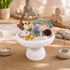 White crystal tree centerpiece on pedestal with turquoise branches, gray crystal rock, and amber stones