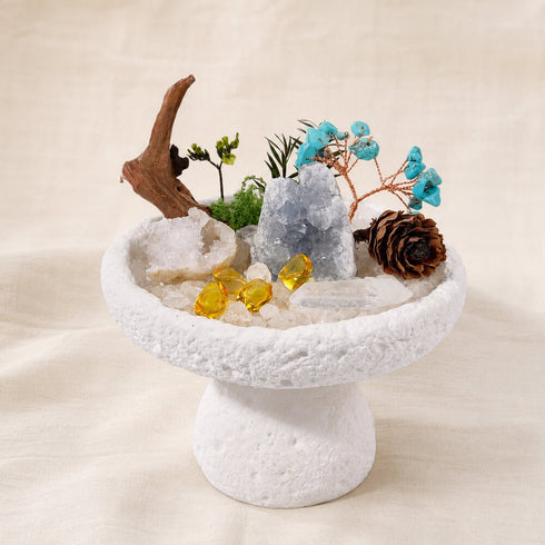 Front view of white crystal tree centerpiece with gray crystal, turquoise branches, yellow stones, pinecone