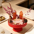 Red crystal garden kit centerpiece with orange crystal points, pink sprigs, and pinecone accent