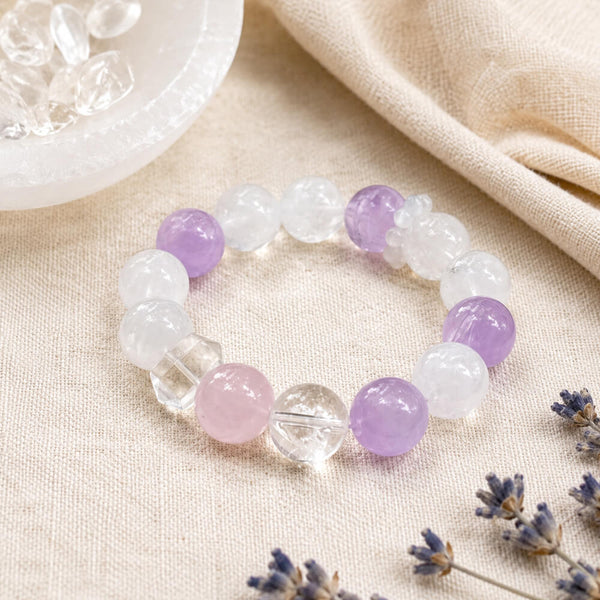 Crystal bracelet with pale pink, lavender, and clear round beads on an elastic band