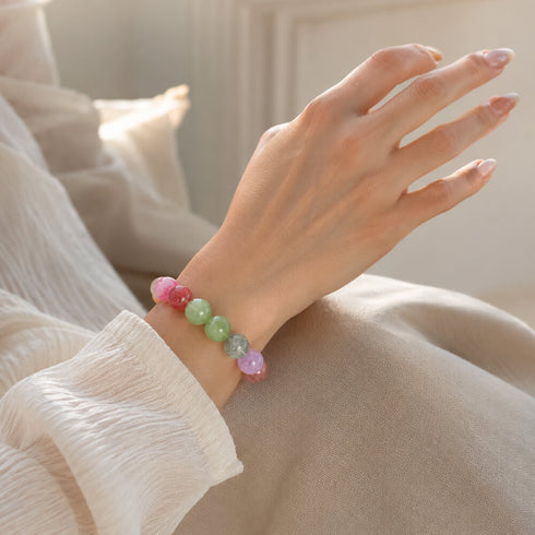 Multicolor crystal bracelet on wrist, round beads in pink, mint, and light green
