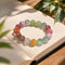 Multicolor beaded bracelet on paper with round pastel crystals in purple, green, pink, and orange