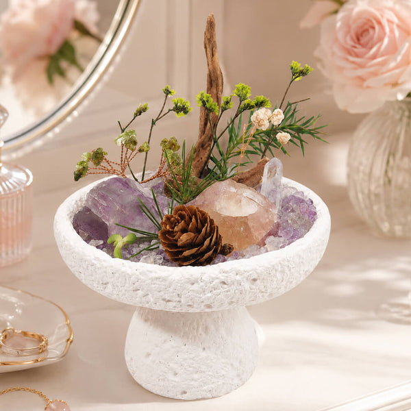 Natural crystal bonsai centerpiece on white stone pedestal with purple crystal and greenery