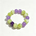Purple and green gemstone bead bracelet with faceted cube accent
