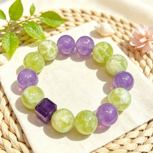 Purple and lime green gemstone bead bracelet on fabric with leaf decor
