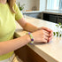 Purple and green crystal bead bracelet worn on wrist